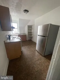 a kitchen with refrigerator and window