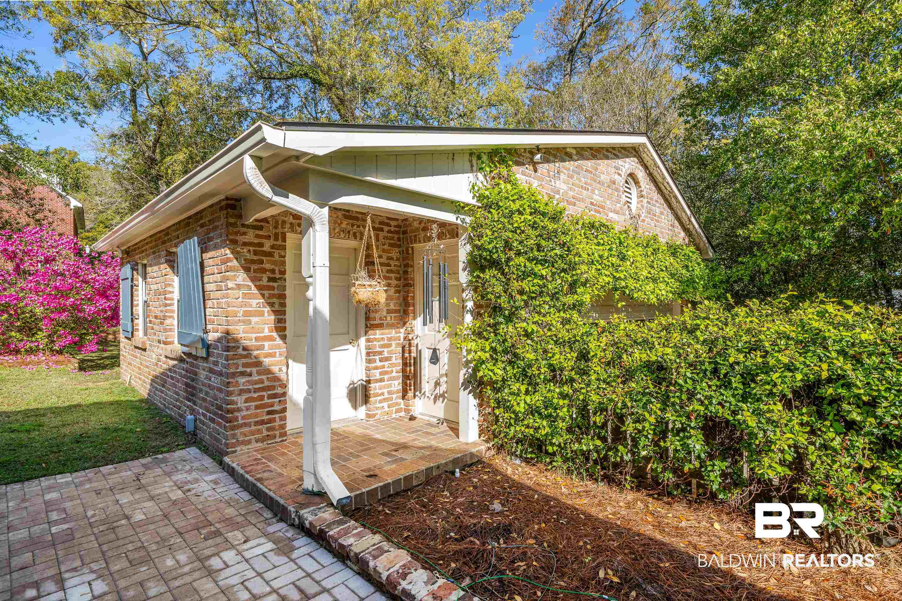 141 Myrtlewood Lane Mobile, AL 36608 - Photo 41 of 44 View of front of home with brick siding, a front yard, and board and batten siding