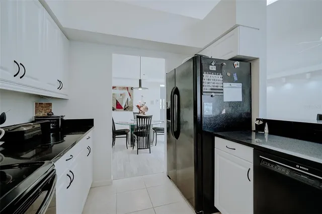 a kitchen with stainless steel appliances a refrigerator and a stove top oven