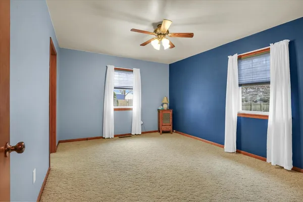 a view of a big room with closet and a chandelier fan