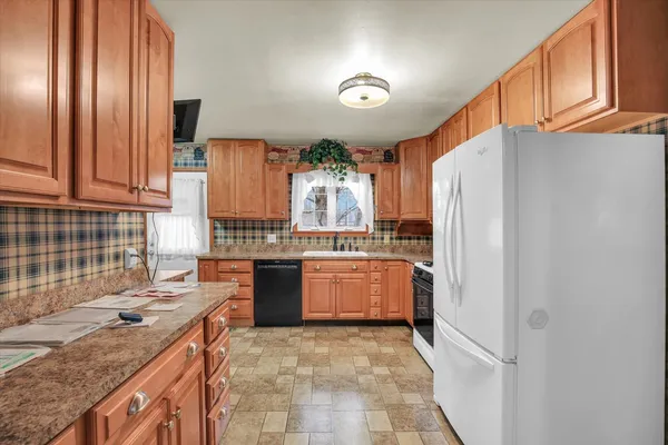 a kitchen with a sink stove and refrigerator