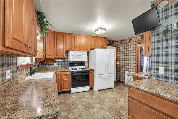 a kitchen with stainless steel appliances granite countertop a refrigerator stove and sink