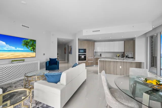 a bedroom with a large bed and a flat tv screen on dresser