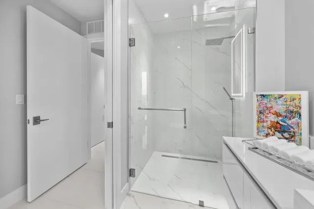 a bathroom with a tub a sink a toilet and a shower