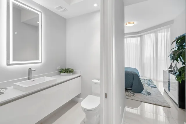 a view of a hallway with wooden floor and stairs