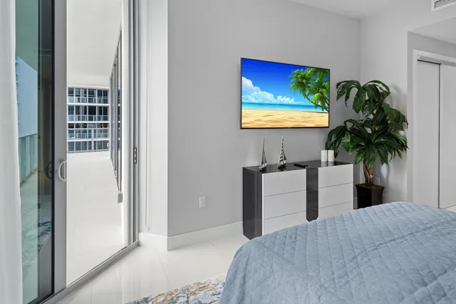 a very nice looking living room with furniture and floor to ceiling windows