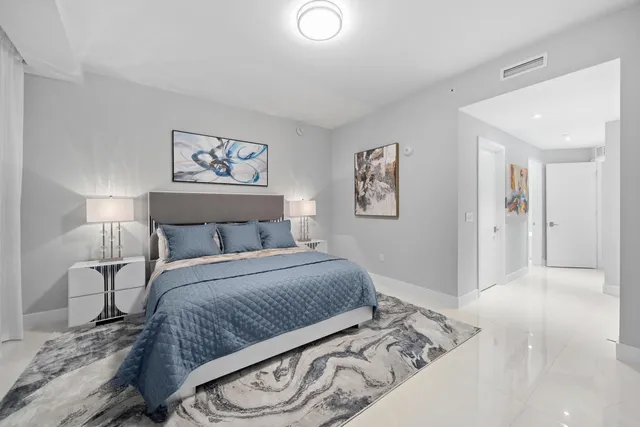 a dining room with furniture and a large window