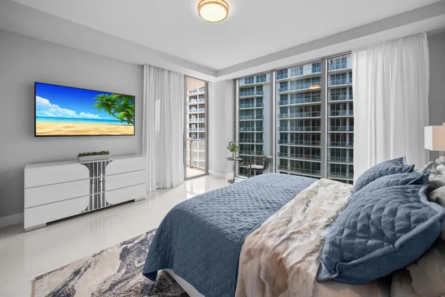 a living room with furniture and large windows