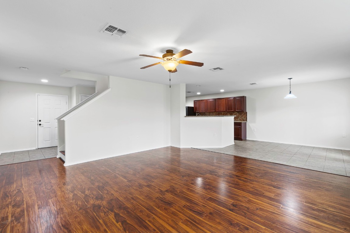 11412 Barns Trail Austin, TX 78754 - Photo 5 of 20 Unfurnished living room featuring dark wood-style flooring, recessed lighting, ceiling fan, and stairway
