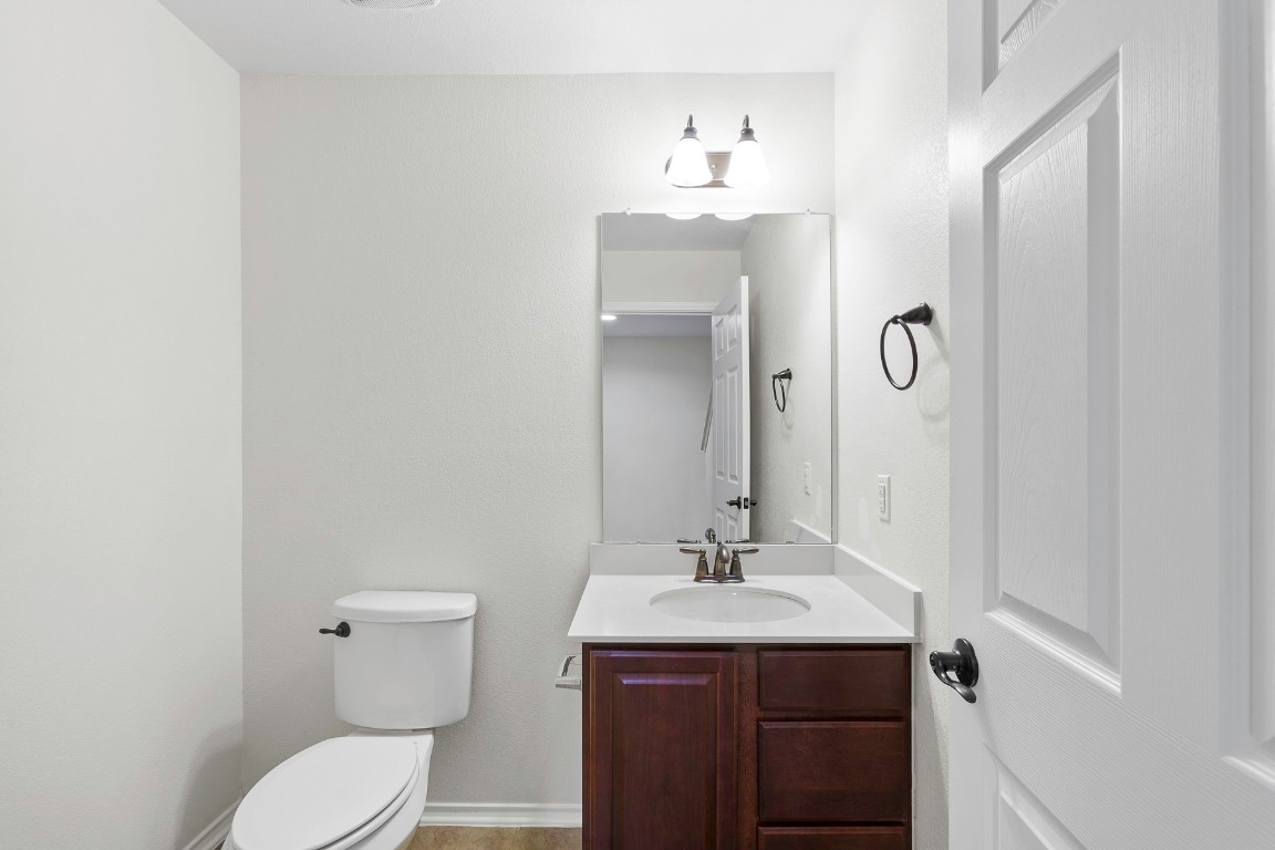 11412 Barns Trail Austin, TX 78754 - Photo 7 of 20 Half bathroom with vanity and toilet