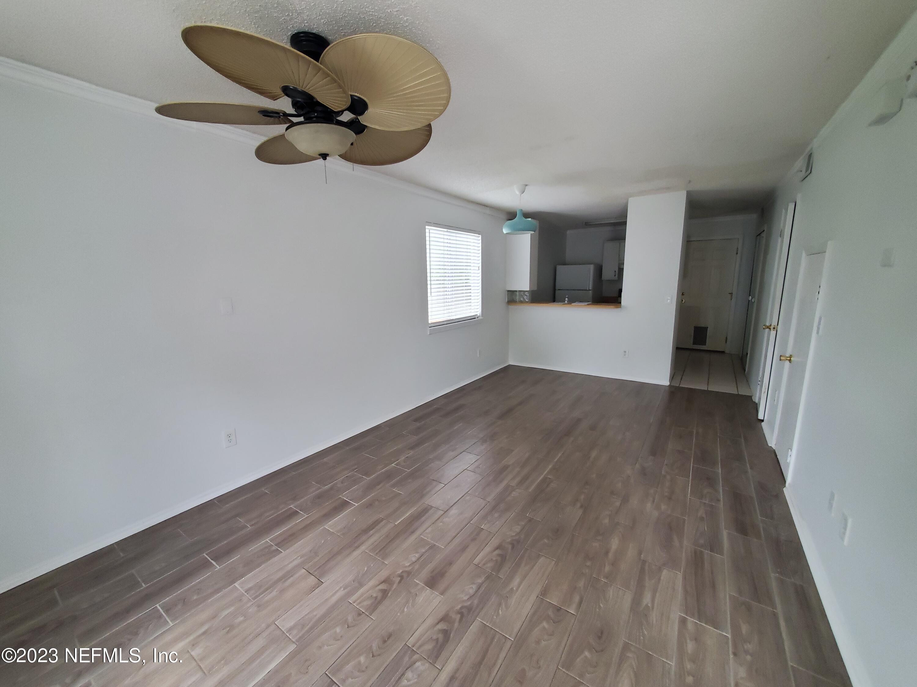 2200 Marsh Point Road Neptune Beach, FL 32266 - Photo 2 of 13 an empty room with wooden floor and windows