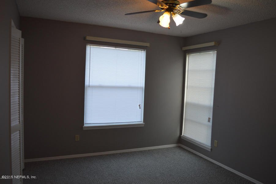 2200 Marsh Point Road Neptune Beach, FL 32266 - Photo 10 of 13 an empty room with a window and a ceiling fan