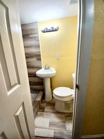 a bathroom with a toilet and a sink