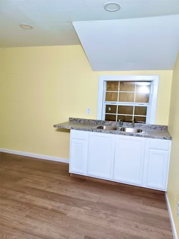 a view of kitchen with granite countertop window