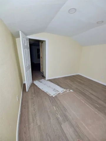 an empty room with wooden floor and closet