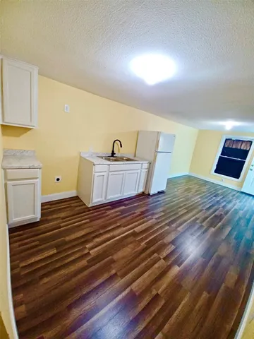 a view of a room with wooden floor