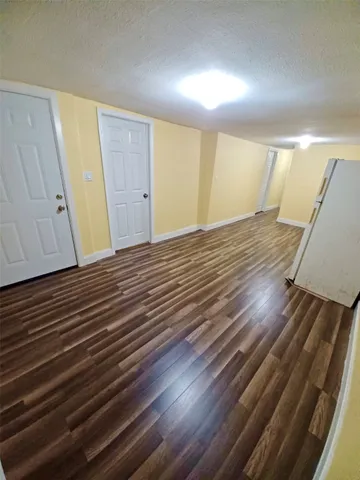 a view of room with wooden floor