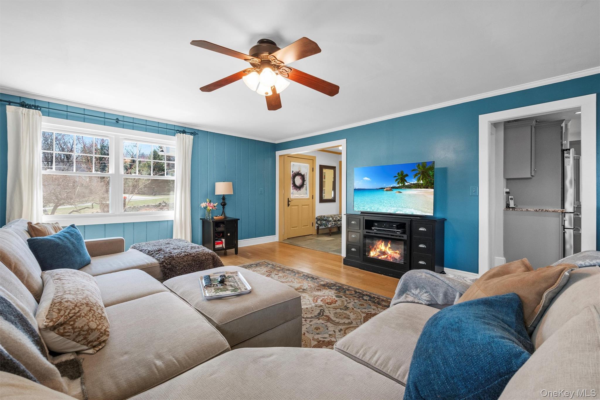 76 Smith Hill Road Monsey, NY 10952 - Photo 24 of 50 a living room with furniture a fireplace and a flat screen tv