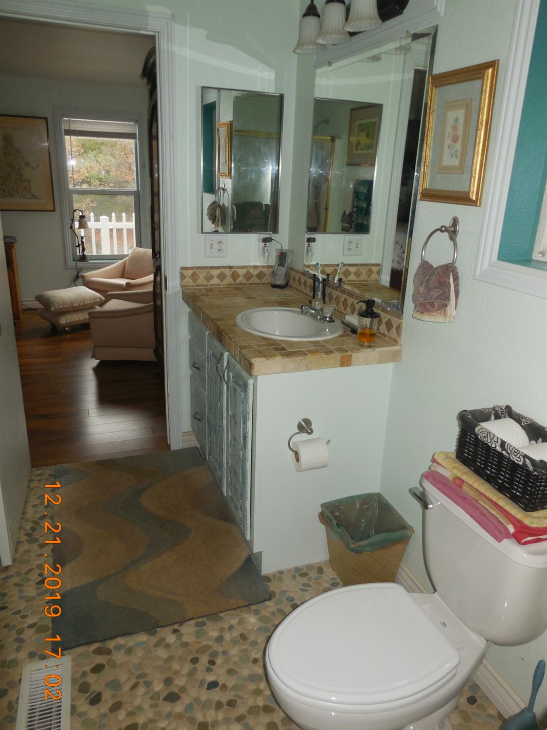 6067 Sheep Ranch Road Murphys, CA 95247 - Photo 32 of 44 a bathroom with a sink a toilet a mirror and vanity