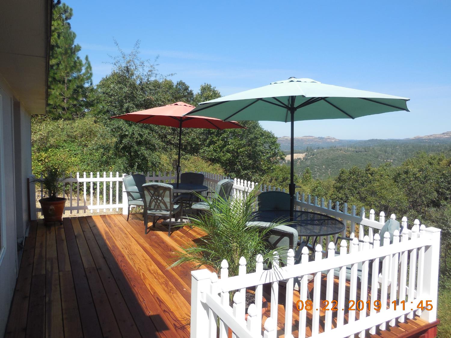 6067 Sheep Ranch Road Murphys, CA 95247 - Photo 5 of 44 a view of a balcony with chair and umbrella