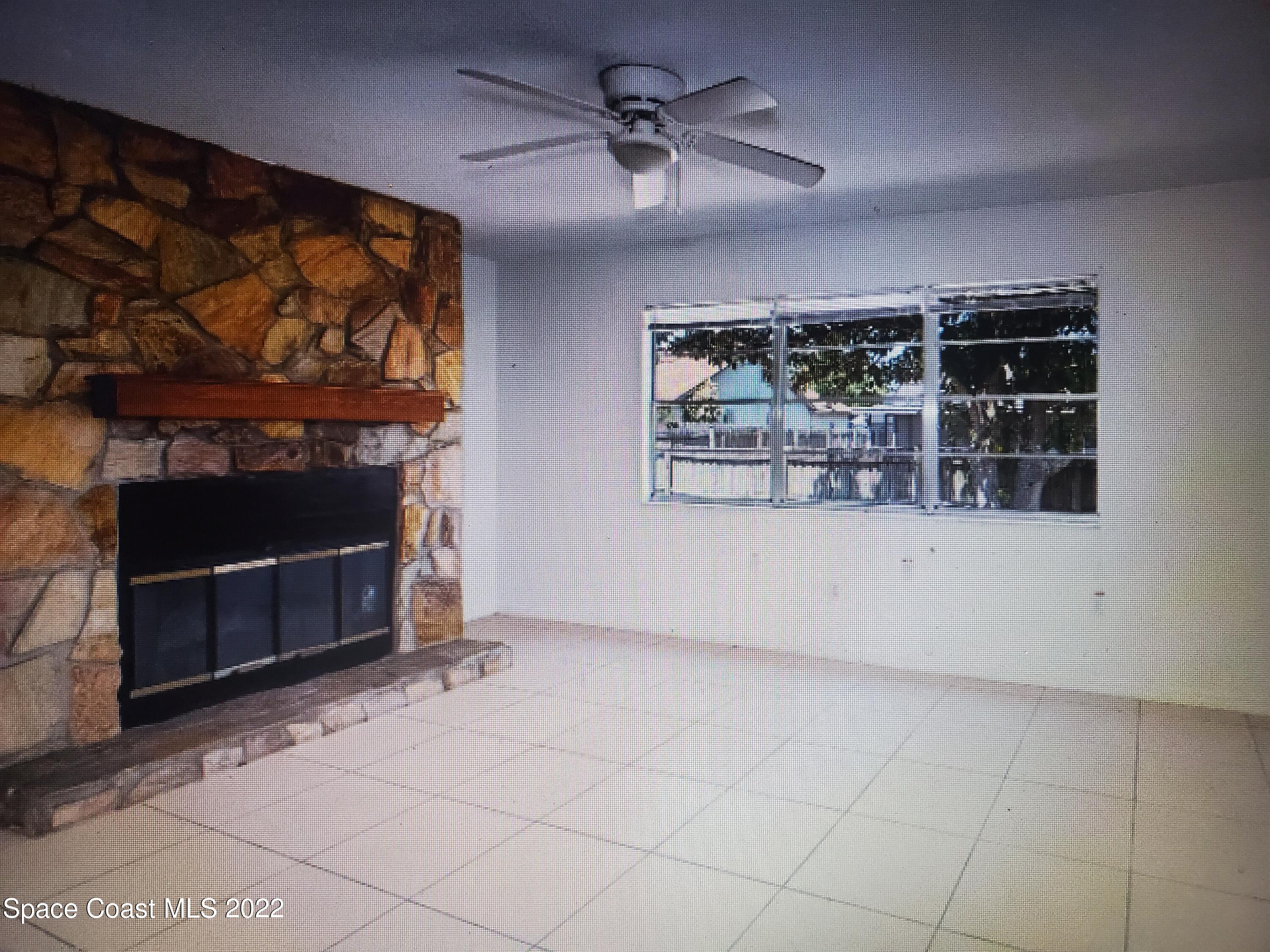 3716 Ranger Street Titusville, FL 32796 - Photo 5 of 7 a view of a fireplace and window in the room