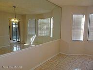 3716 Ranger Street Titusville, FL 32796 - Photo 6 of 7 a view of a room with windows and chandelier
