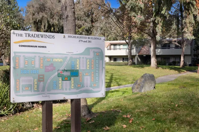 a view of a back yard with a table and chairs