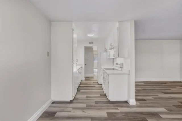 a view of a kitchen from the hallway