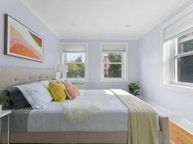 a bedroom with a bed and a window