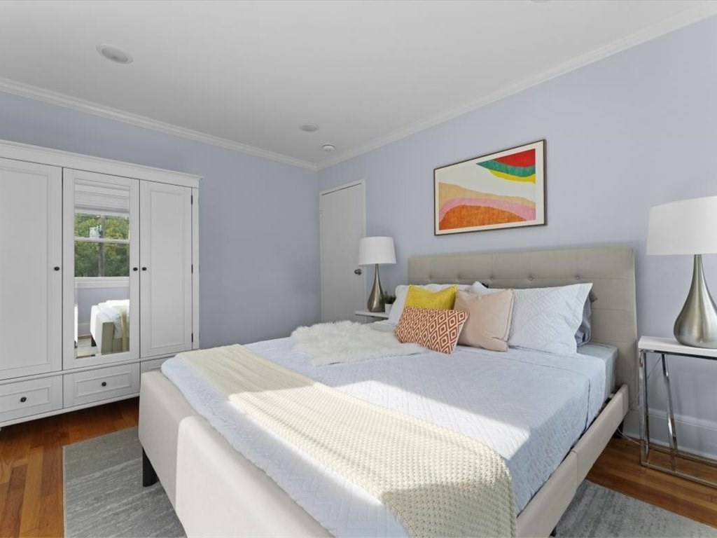 1 Catenaccia Way, Unit 47 Boston, MA 02130 - Photo 14 of 27 a bedroom with a bed and painting on the wall
