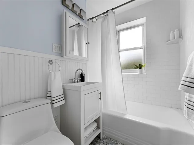 a bathroom with a bathtub a sink and a shower
