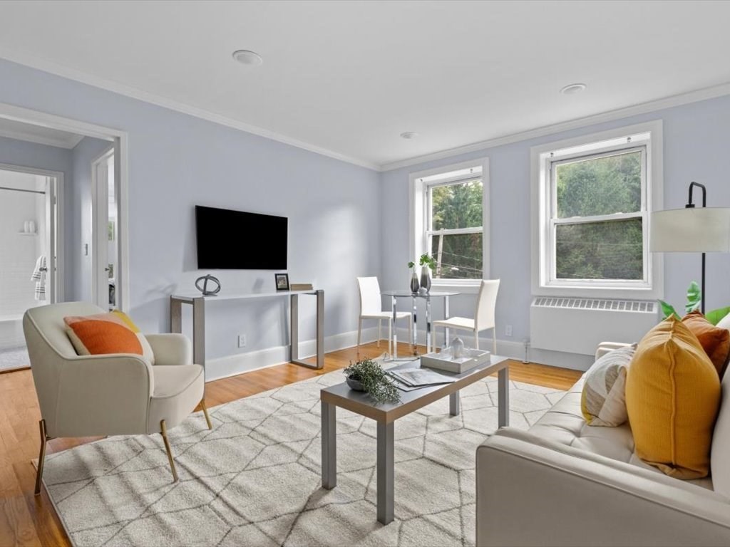 1 Catenaccia Way, Unit 47 Boston, MA 02130 - Photo 2 of 27 a living room with furniture a flat screen tv and a window