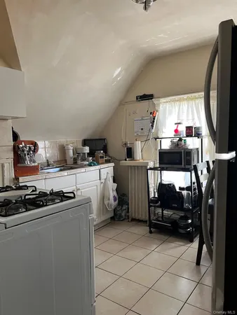 a kitchen with furniture a stove and a refrigerator