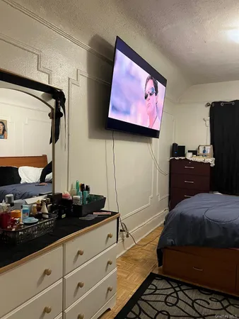 a bedroom with a bed and a potted plant