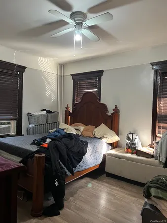 a bedroom with furniture and a flat screen tv