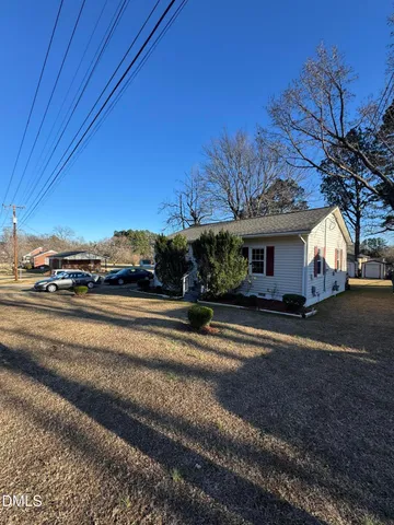 a view of street along with house and trees