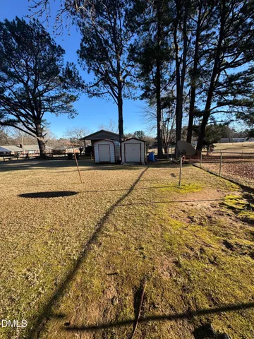 a view of yard with large trees