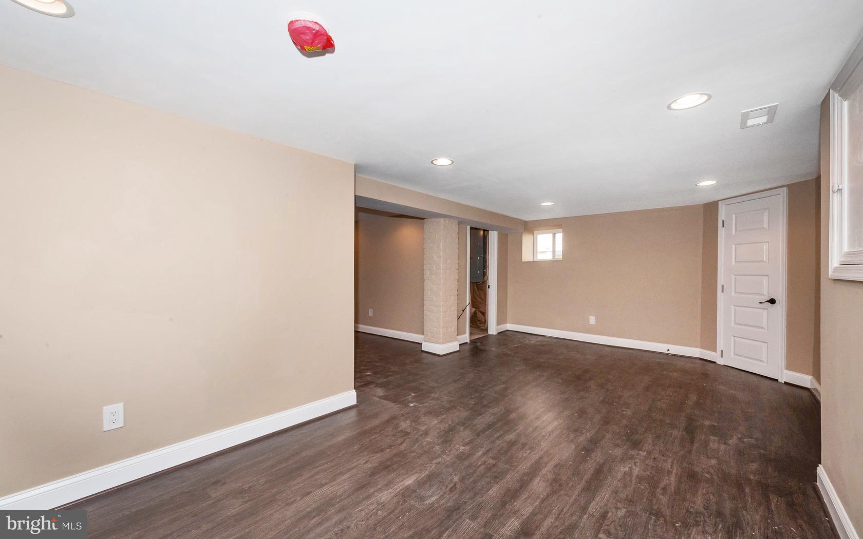 3224 Shelburne Road Baltimore, MD 21208 - Photo 22 of 26 a view of an empty room with wooden floor and cabinet