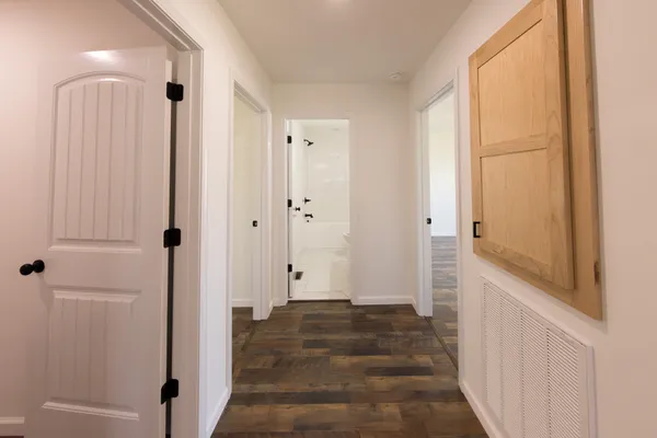 a view of a hallway with wooden floor and staircase