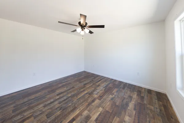 a view of a room with wooden floor