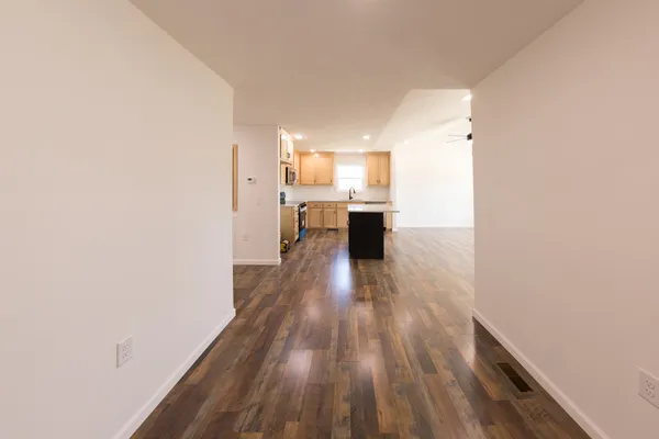 a view of a kitchen from the hallway