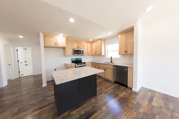 a kitchen with a sink window and cabinets
