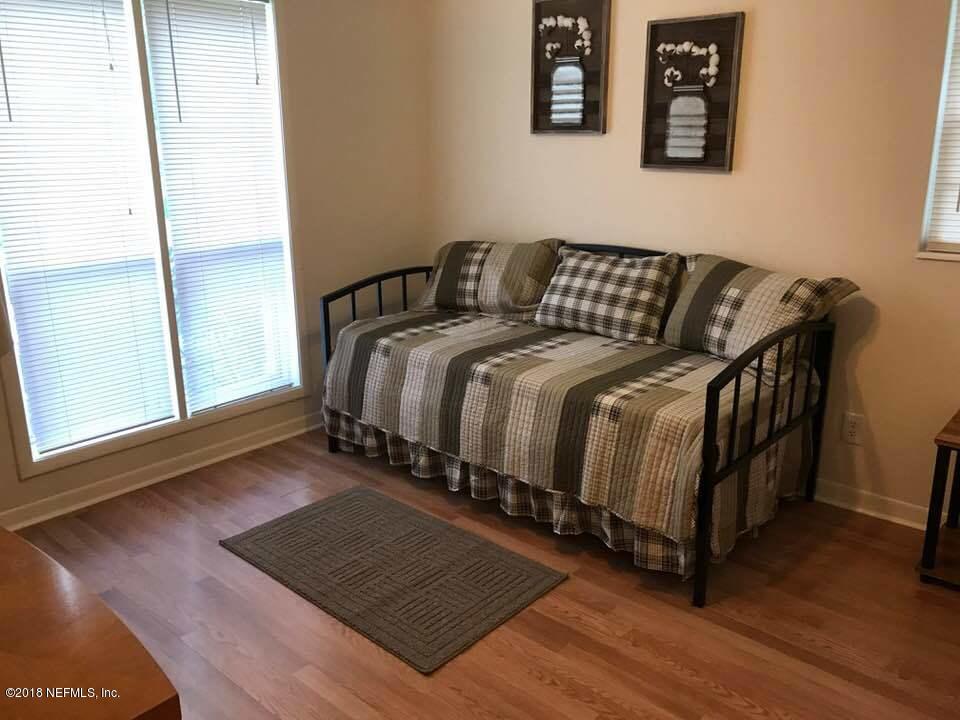 5412 Community Road Jacksonville, FL 32207 - Photo 10 of 17 a bedroom with a bed and wooden floor