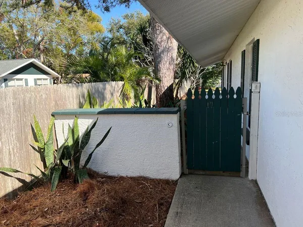 a view of a house with a yard and potted plants