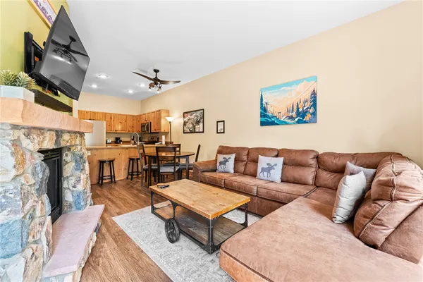 a living room with furniture kitchen view and a fireplace