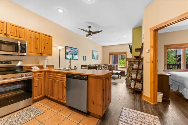 a large kitchen with stainless steel appliances granite countertop a stove and a sink