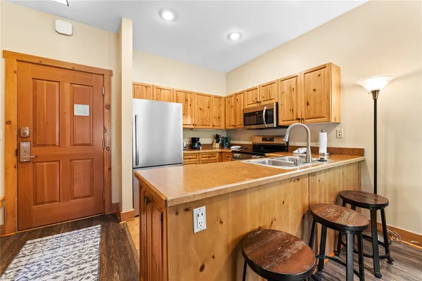 a kitchen with stainless steel appliances a refrigerator and a stove