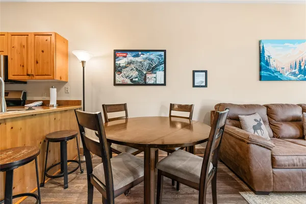 a view of a dining room with furniture and a kitchen