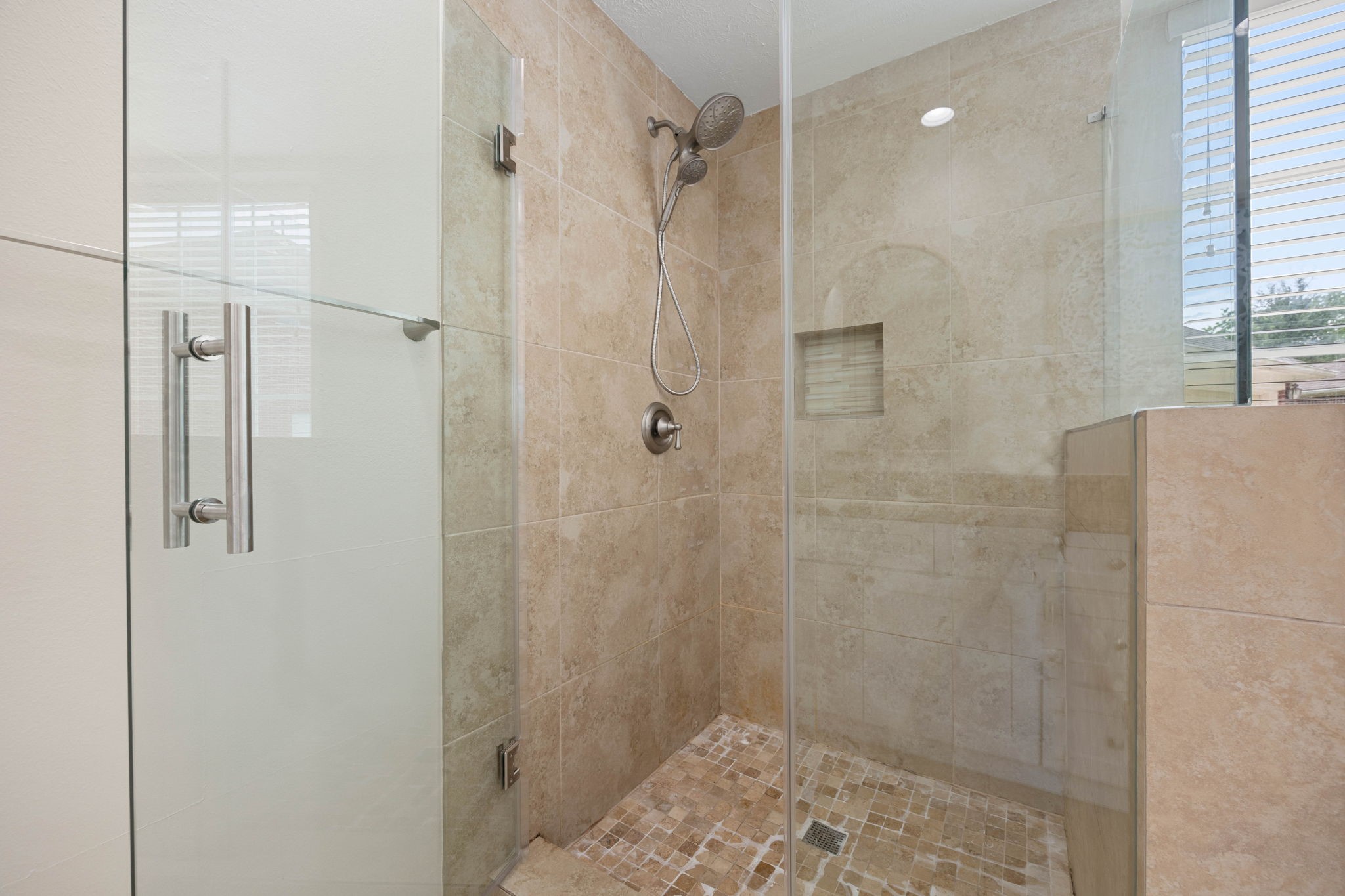 6335 Borg Breakpoint Drive Spring, TX 77379 - Photo 24 of 39 Primary bath features an oversized walk-in shower with glass enclosure and tiled surround.