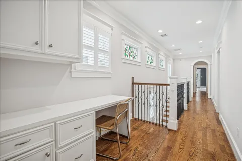 a view of a livingroom with wooden floor and staircase